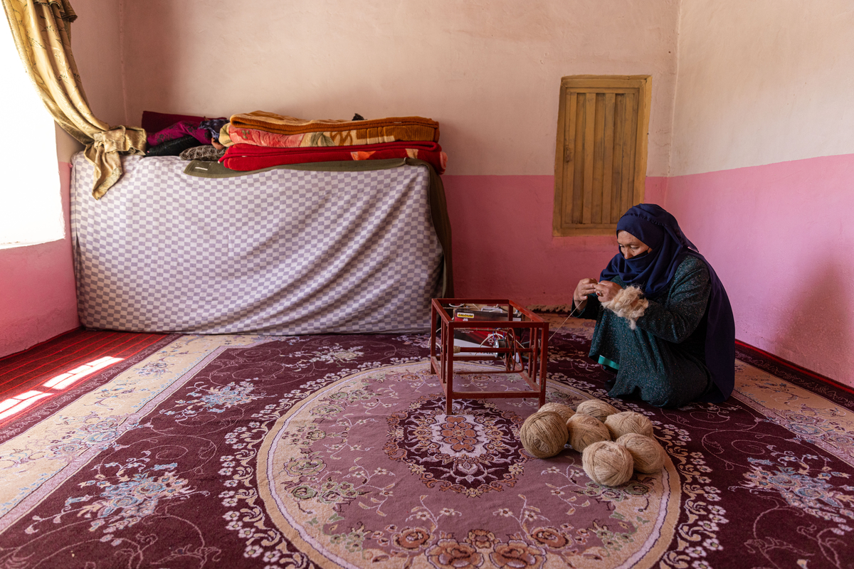 48-year-old Fatemeh from Kate Sang village, Bamyan province, spinning with new spinning machines