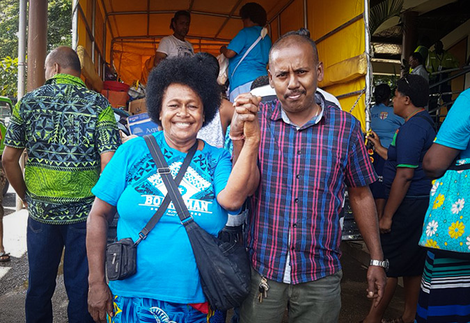 Nausori Market Vendors Association President, Venina Vakarusere (left) and Nitesh Prasad, Ba Market Vendors Association President (right) at the handover of ration packs following severe floods in Fiji. Photo: UN Women/ Mouna Peters