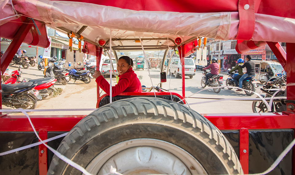 Padma Chaudhary waits for passengers in Dhangadhi bazar. She says she used to feel uncomfortable when she first started, but now feels confident about her skills as a driver. Photo: UN Women/Merit Maharjan