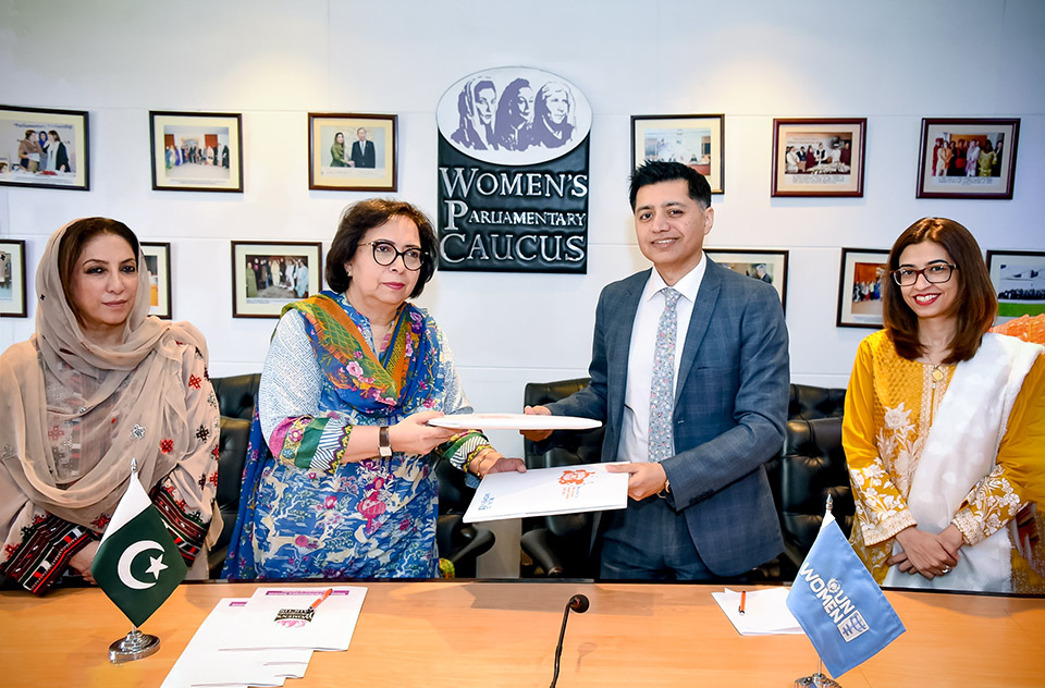 WPC Secretary Munazzah Hassan and UN Women Country Rep Jamshed Kazi exchange documents after signing MoU at National Assembly. Photo: UN Women/Habib Asgher