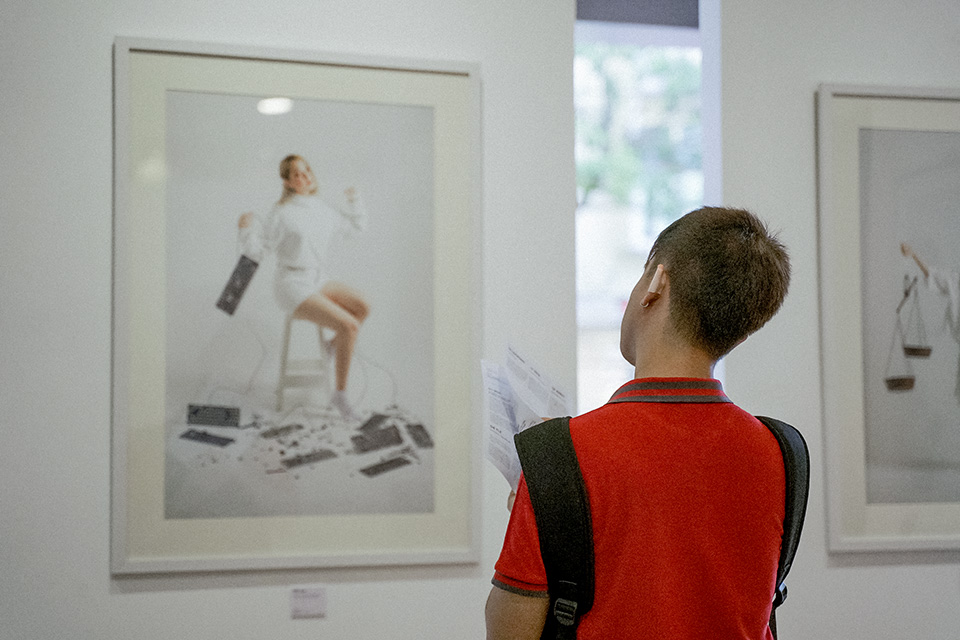 A visitor looks at photographs in the exhibition. Photo: Courtesy of IKIGAI
