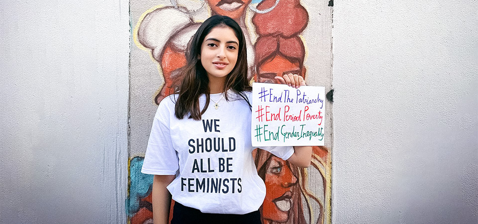 Nanda shows her messages outside Fashion Institute of Technology In New York City, on 3 April 2021. Behind her is a student-painted mural on the theme of Black Lives Matter, with a focus on empowering black women. Photo: Courtesy of Gauri Kanade