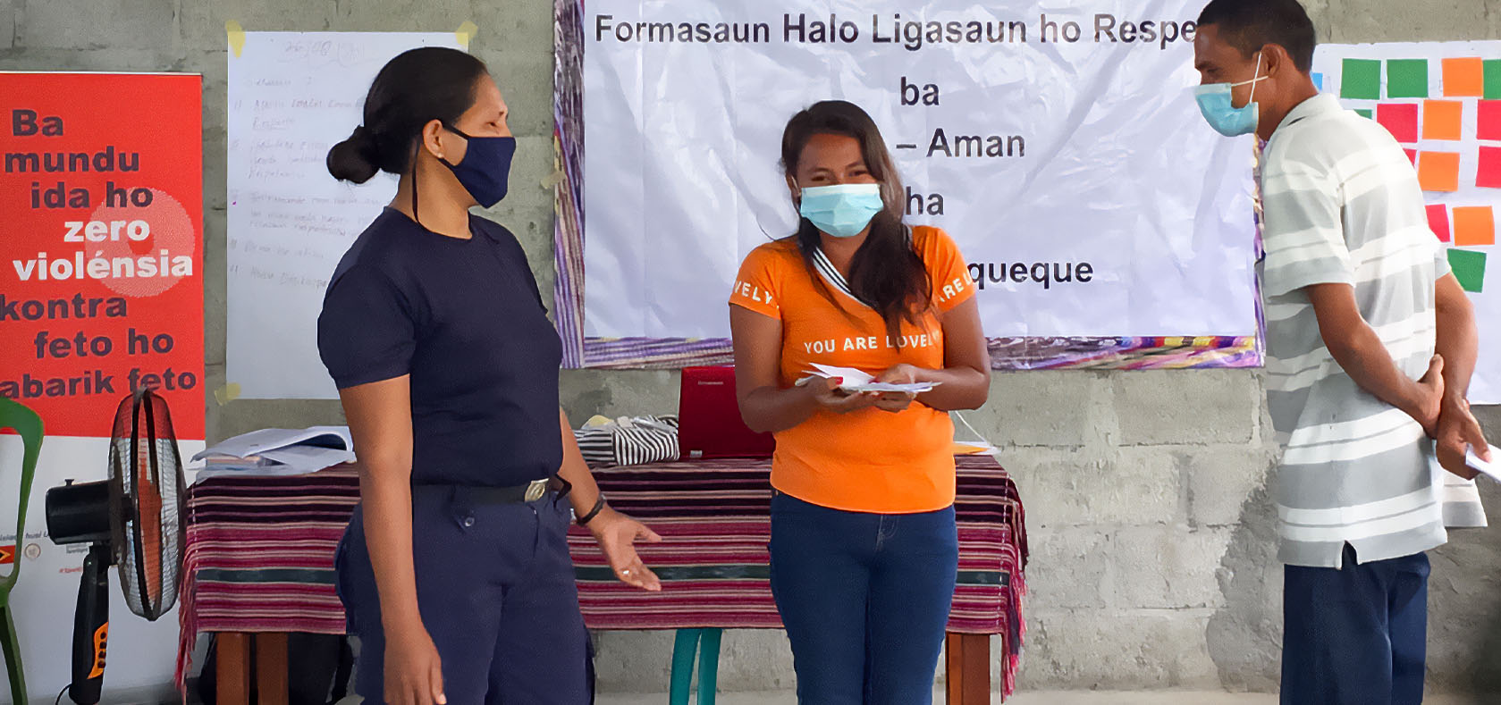 (From left) A police officer, a mother and a father do a role play on non-violent relationships with children at home for a Positive Parenting Session in Viqueque municipality of Timor-Leste on 26 August 2021. Photo: UN Women/Sylvio da Fonseca