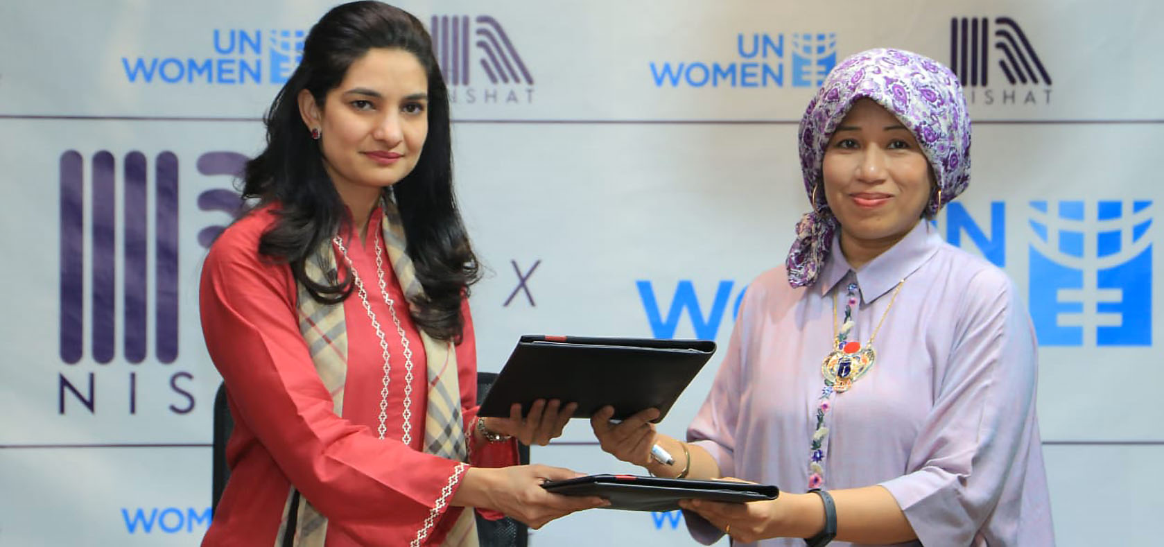 Sharmeela Rassool, Country Representative, UN Women Pakistan and Wajeeha Khalid - Business Head, Nishat Mills Ltd (Apparel Division) exchanging the signed agreements. Photo: Nishat Apparel/Ahmed Zaheer