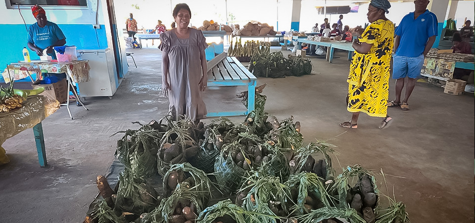 Market vendor Isabel Vokraei with her produce at Luganville Market. Photo: UN Women