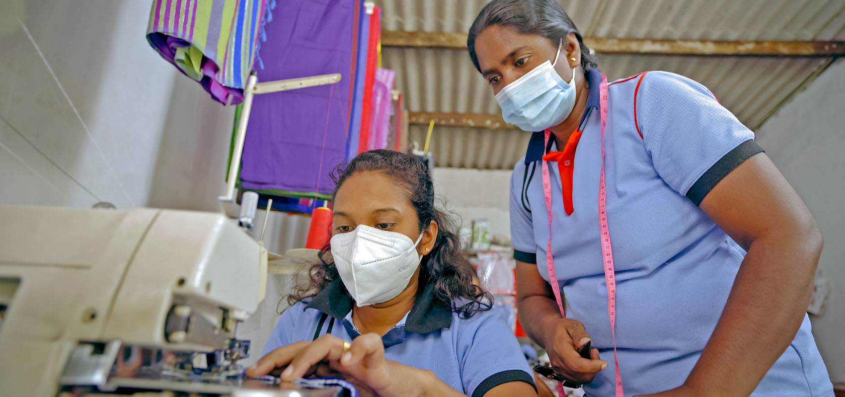 Social activist Rupa Damayanthi (right) teaches a young woman how to sew, on 9 March 2022 in Monaragala, Uva Province, Sri Lanka. Photo: UN Women/Raveendra Rohana
