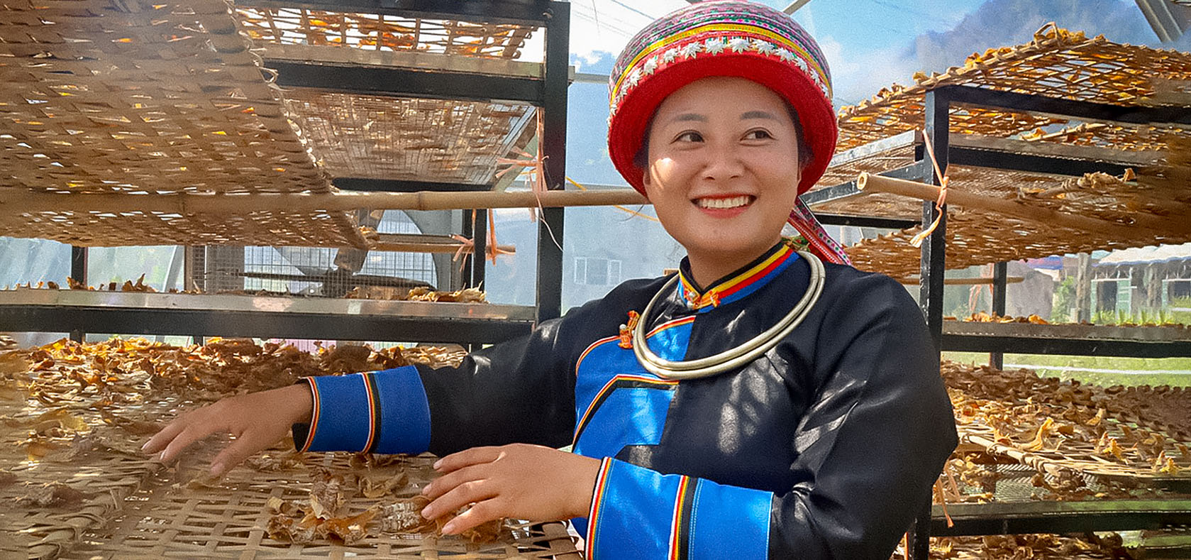 An indigenous woman in Viet Nam uses solar drying systems provided by the EmPower project. Bắc Kạn Province, October 2022. Photo: UN Women/Hoang Thao