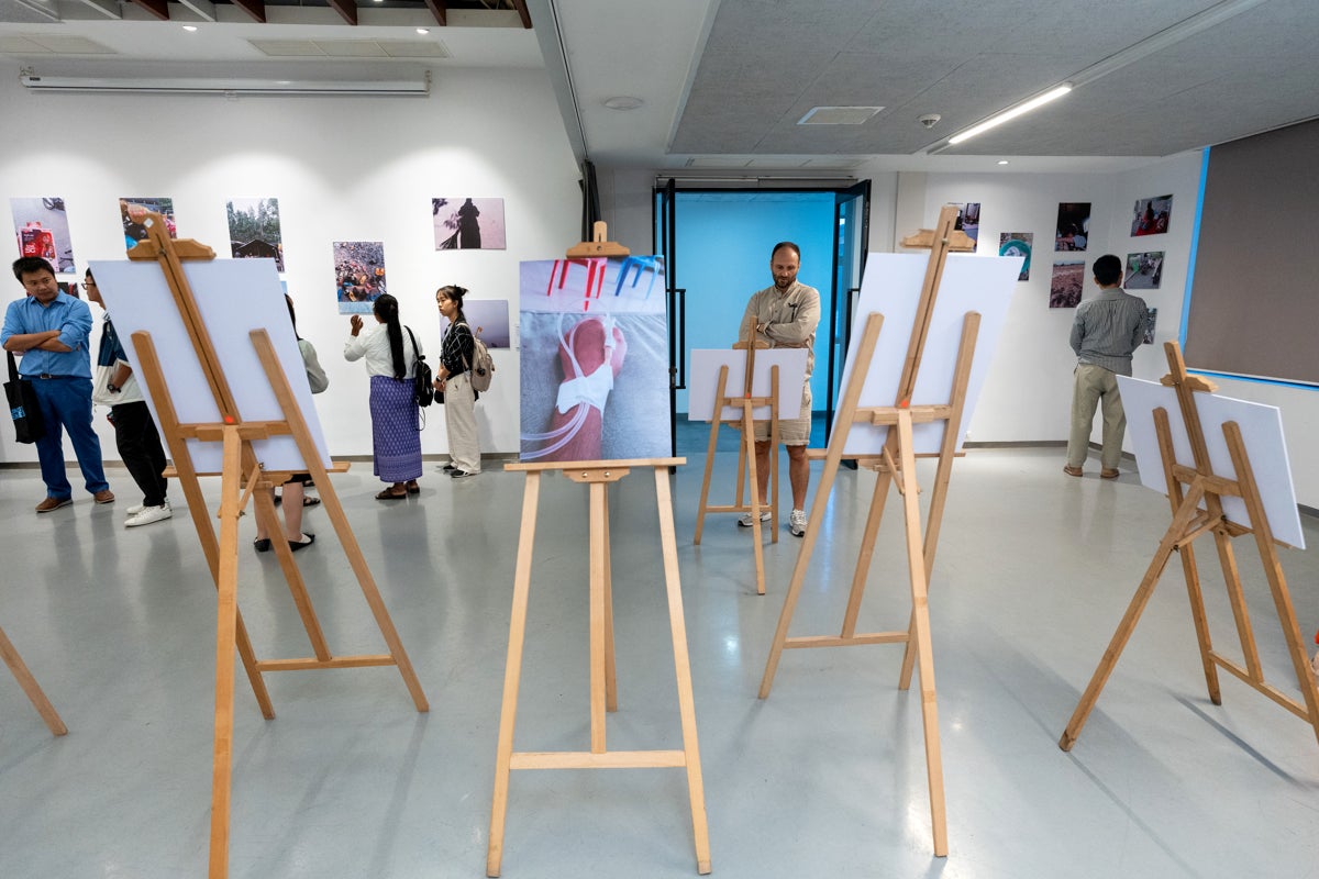 Visitors view exhibited works at Raintree, Phnom Penh, Cambodia.