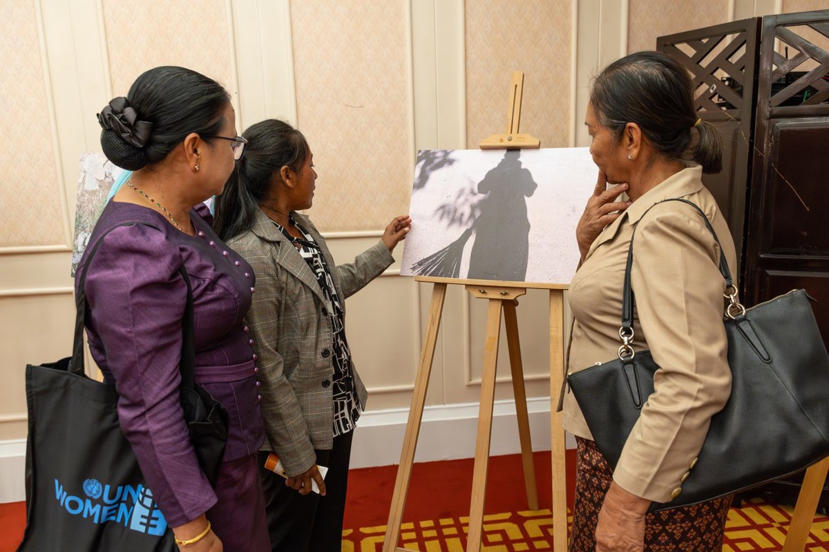 A group of guests look at an exhibited photograph.