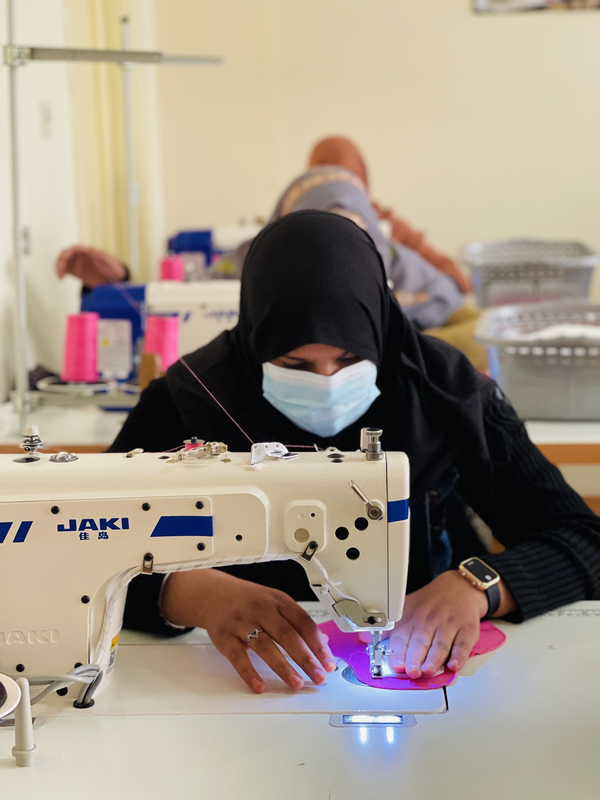 Maryam sews a high-quality reusable sanitary pad as part of her skills training under a UN Women-supported women's empowerment project in Kandahar. 