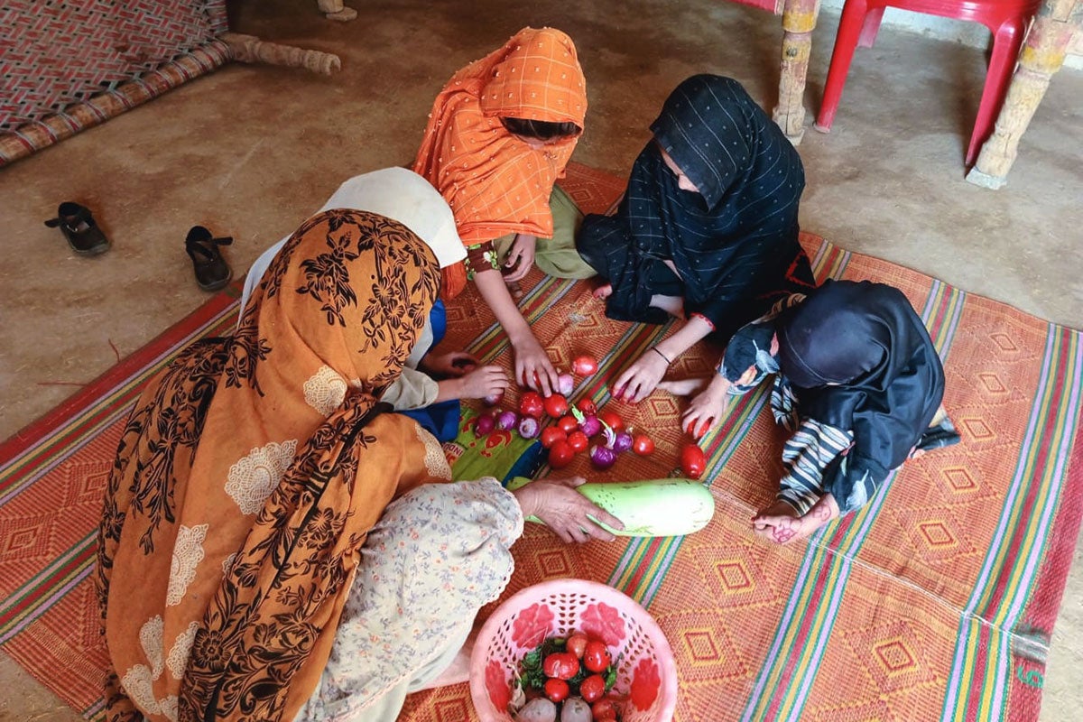 Yasmin Gul is photographed with her daughters and granddaughter, doing chores at home. 