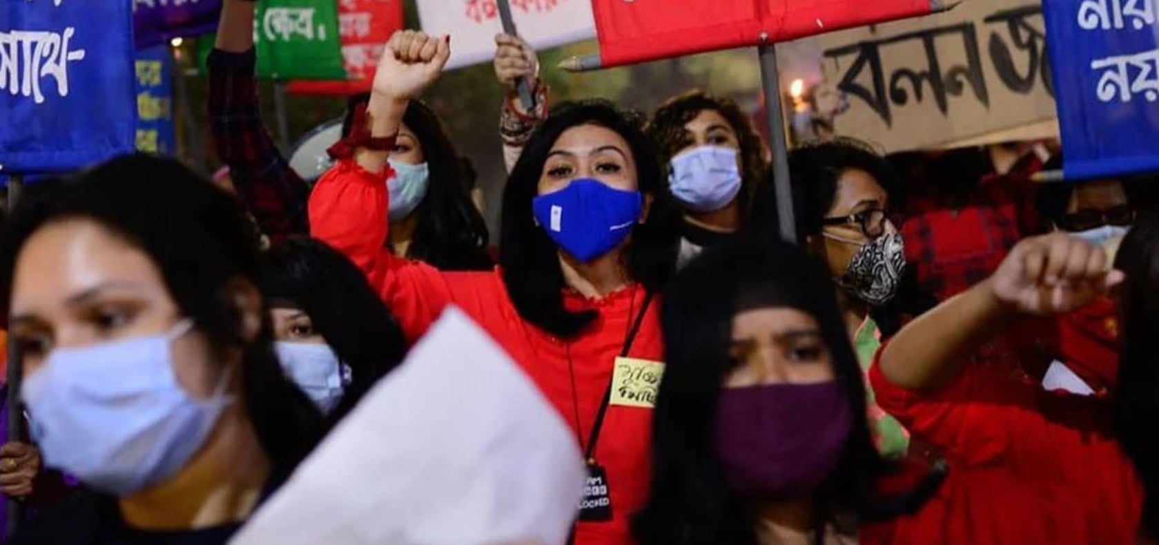 Women hold signs and gather in an evening rally organized by Feminists Across Generations in Bangladesh in 2020. The rally aimed to reclaim public spaces to mobilize public outrage against the normalization of sexual violence and rape culture. 