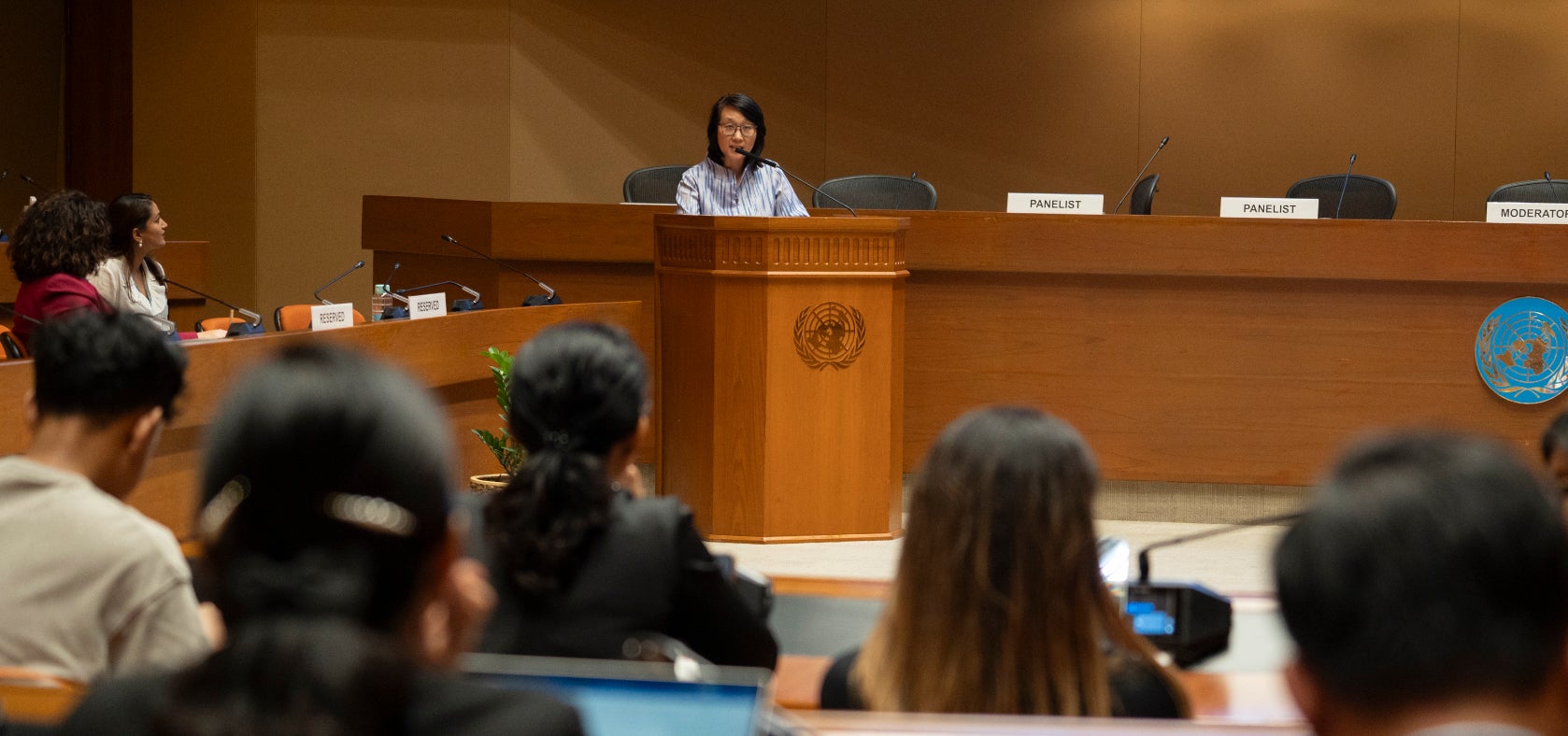 Cai Cai, Chief of the Gender Equality and Social Inclusion Section at ESCAP speaks at the podium stressing that the care economy is essential for human survival, welfare, and economic growth. 