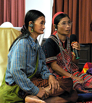 Soi Tonnampet and Kruemebuh Chaya, both members of the Karen tribe from Keng Kra Chan, Thailand, share their experiences of violence and displacement with the group during a story-telling session. Photo: UN Women/Jo Baker
