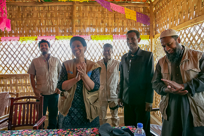 UN Women Executive Director, Phumzile Mlambo-Ngcuka claps after she pins "HeForShe" pins on CIC's in charge of camps, Shamimul Huq Pavel, Muhammed Talut, and ASM Obaidullah in Balukhali Rohingya Refugee camp February 1, 2018 in Chittagong division, Bangladesh. Photo: UN Women/Allison Joyce