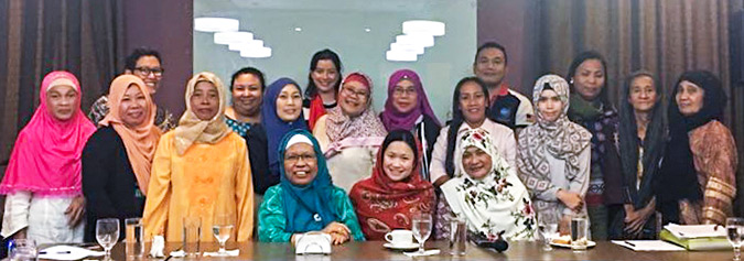 With women leaders from Mindanao who are at the frontlines of preventing violent extremism within their communities. Photo: UN Women/Malberry Suites