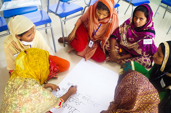 The garment factory workers do a group activity in the training given by UN Women and CARE to improve their lives. Photo: CARE/Kazi Mirzan