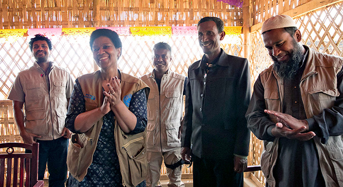 UN Women Executive Director, Phumzile Mlambo-Ngcuka  pins "He For She" pins on CIC's in charge of camps, Shamimul Huq Pavel, Muhammed Talut, and ASM Obaidullah in Balukhali Rohingya Refugee camp February 1, 2018 in Chittagong district, Bangladesh.   Photo: UN Women/Allison Joyce