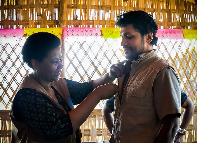 UN Women Executive Director, Phumzile Mlambo-Ngcuka pins "He For She" pins on CIC's in charge of camps, Shamimul Huq Pavel, Muhammed Talut, and ASM Obaidullah in Balukhali Rohingya Refugee camp February 1, 2018 in Chittagong district, Bangladesh. Photo: UN Women/Allison Joyce