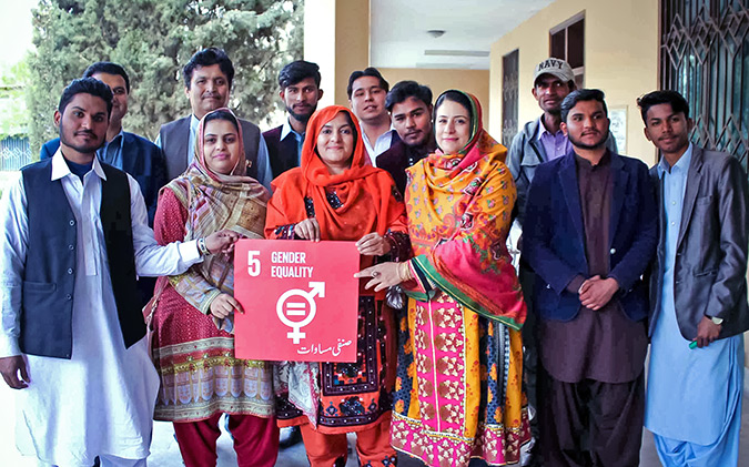 Attendees pose for a picture to show their support to UN Women in achieving Gender Equality. Photo: UN Women/Anam Abbas