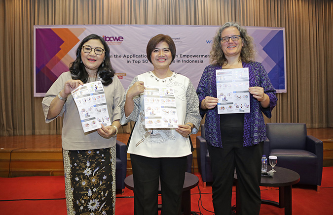 (Right to left) Josephine Satyono, Executive Director IGCN; Maya Juwita, Executive Director IBCWE; Sabine Machl, UN Women Representative, hold a copy of the infographics of the study findings at the WEPs study launch held on 29 August 2018. Photo: UN Women Indonesia/Iwan Kurniawan