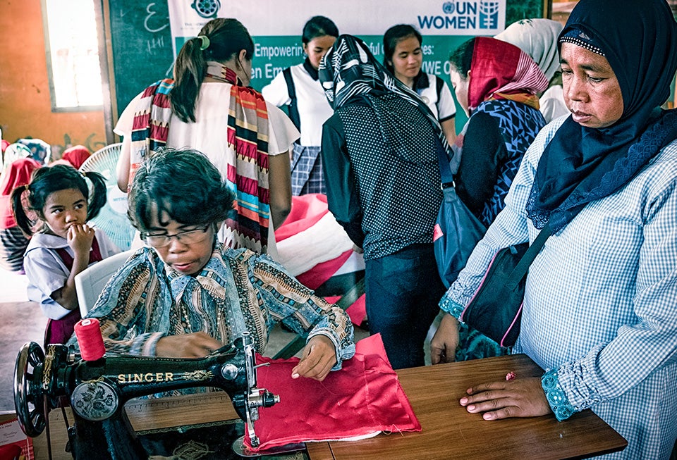 Women in the Bulalo community learn how to sew traditional fabric, which they will then sell as part of a collective. Photo: UN Women/Joser Dumbrique