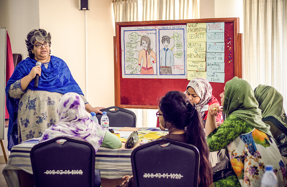 Parveen Huda, a training facilitator at BRAC University, talks about social entrepreneurship with young female university students in Mymensingh, Bangladesh in December 2018. Photo: UN Women/Tasfiq Mahmood