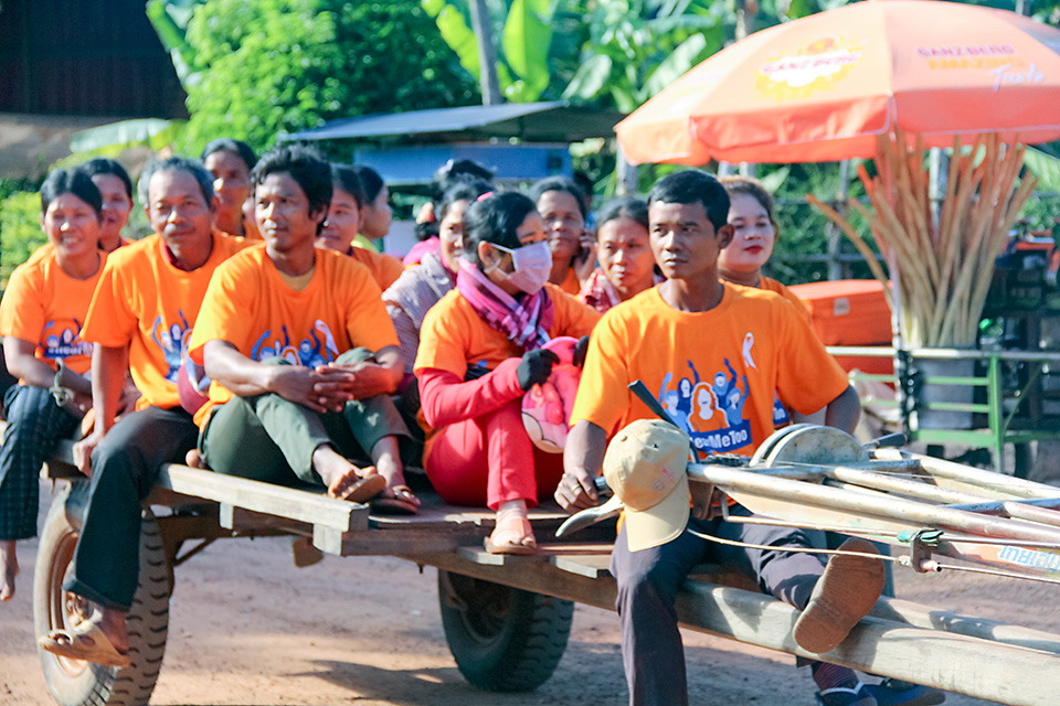 Men on an oxcart join a Government-organized march in Siem Reap, northwestern Cambodia, on 6 December 2018. It was part of the United Nations 16 Days of Activism against Gender-based Violence, for which orange is the theme colour. Photo: UN Women/Vutha Phon