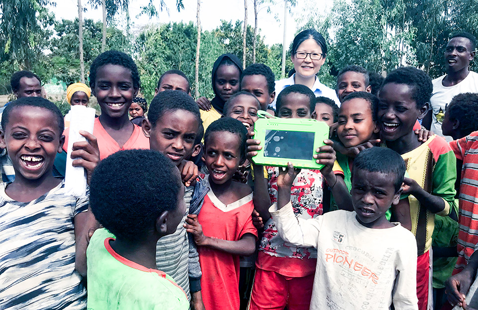 Group photo of Li Xia (last person at the back) and her product users (mostly boys) in Ethiopia). Photo courtesy of Li Xia 