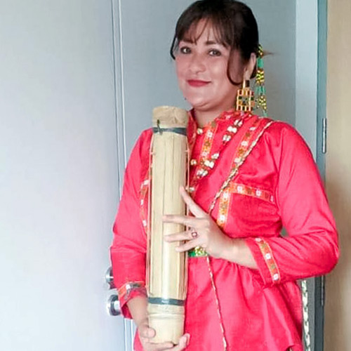 [In the photo, a woman dresses in a red shirt holding an elongate barrel] There is nothing I want more than a peaceful community where we can live in our ancestral domain, practicing our traditional culture. Photo: Aileen Kesa Marie U. Hualde