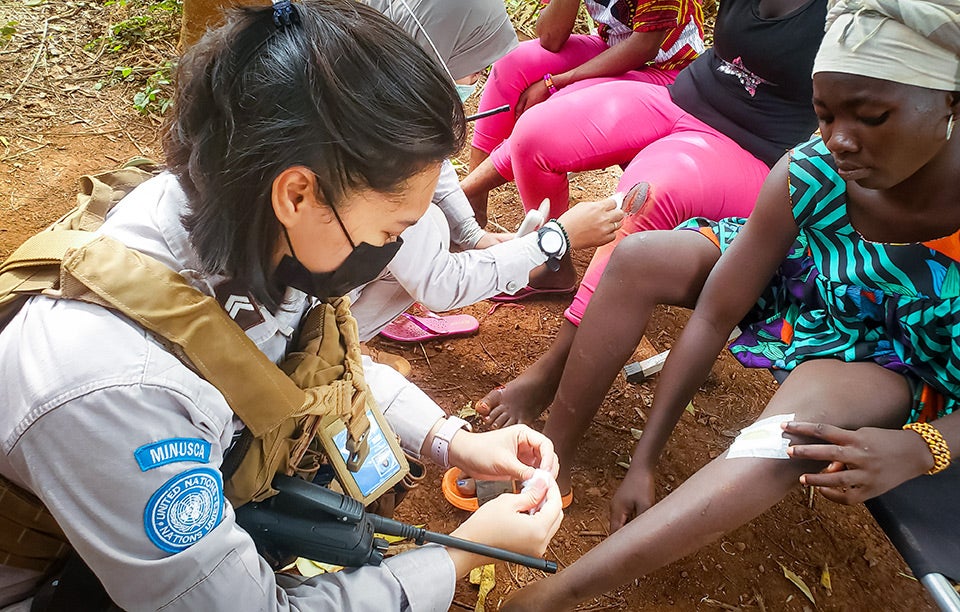 Cecilia and her colleague provide first-aid assistance to the local community after a motorcycle accident as a part of the UN peacekeeping mission in the Central African Republic. Photo: Cecilia Permatasari Ritonga