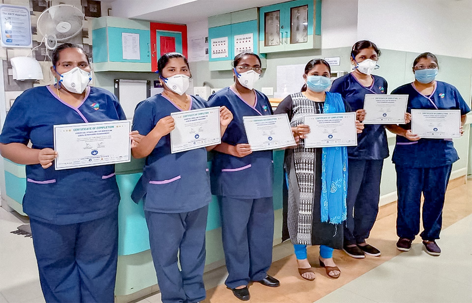 Health workers participating in UN Women India’s Second Chance Education programme display their “Certificate of Completion Essential Upskilling for Nurses on COVID-19 Pandemic Management”. Photo: UN Women