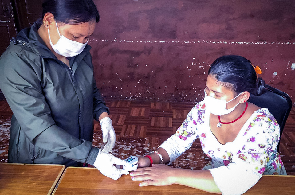 A nurse at Koshish Nepal checks the oxygen level of a person seeking mental health services in their Transit Home. Photo: Courtesy of Sangam Khatri