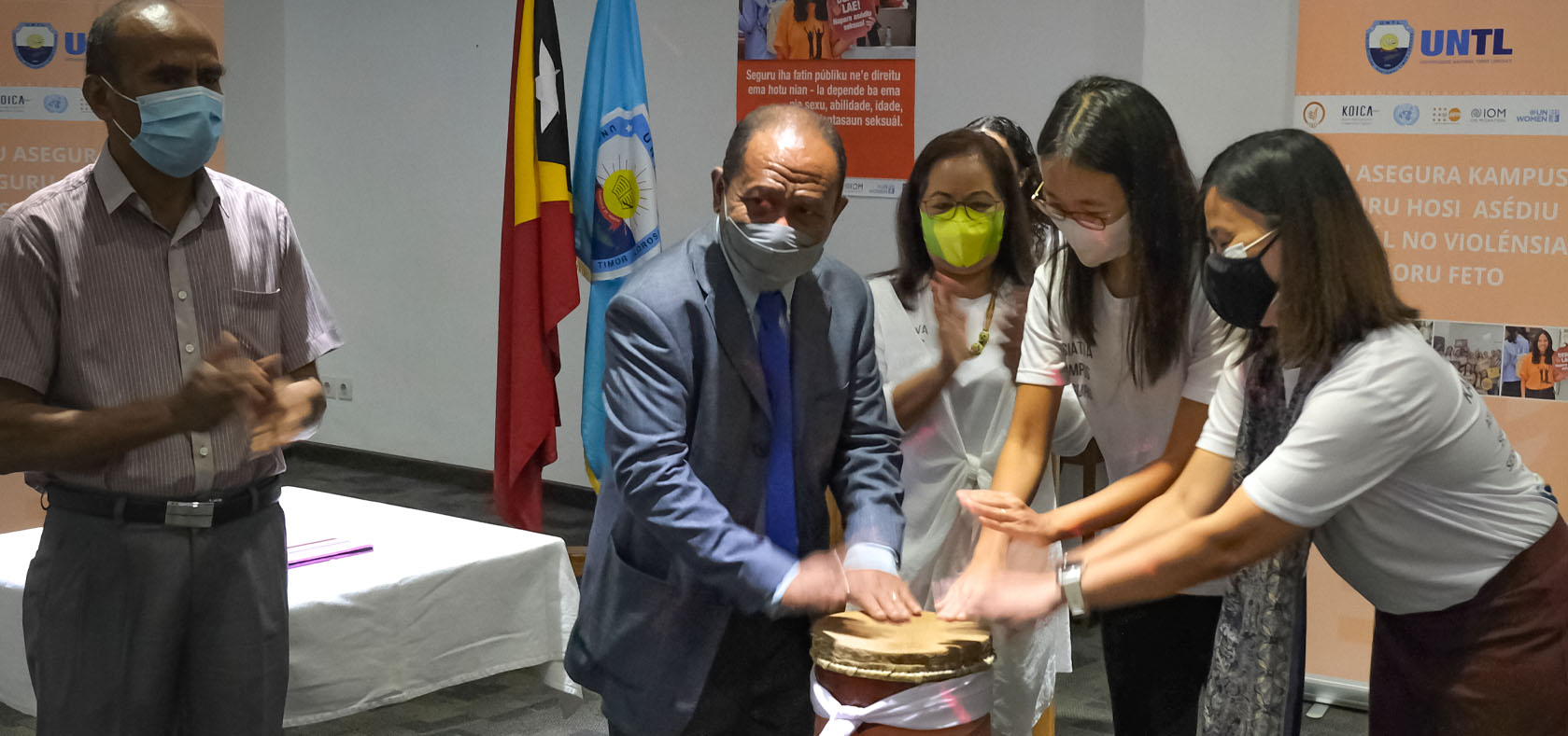 (From left) UNTL Rector Prof. Dr. João Soares Martins, KOICA Country Director Eunju Cha, and UN Women Together for Equality Programme Manager Nuntana Tangwinit do a traditional drum-beating ceremony to launch the Safe Campus Initiative technical working group. The launch took place at Hotel Timor in Dili on 14 October 2021. Photo: UN Women/ Sylvio da Fonseca