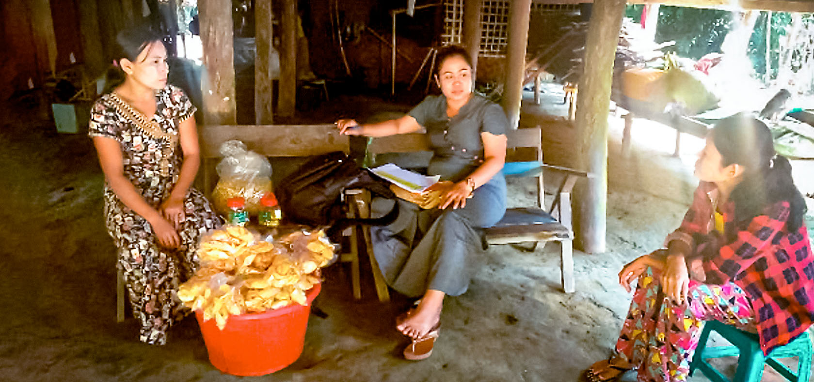 A Meikswe Myanmar representative meeting Daw Aye Mu in her home in Nga Tauk Ta village, Sittwe Township, Rakhine State to inform her that she will be a small-business cash grant recipient. Photo: Meikswe Myanmar/Myat Noe