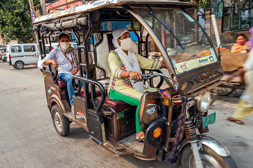A SEWA community leader is seen here driving an e-rickshaw. With women behind the wheels, women passengers often feel safer because sexual harassment in public spaces and transportation is a persistent problem. It also provides women with jobs in a make dominated sector. Photo: UN Women/Prashanth VIshwanathan