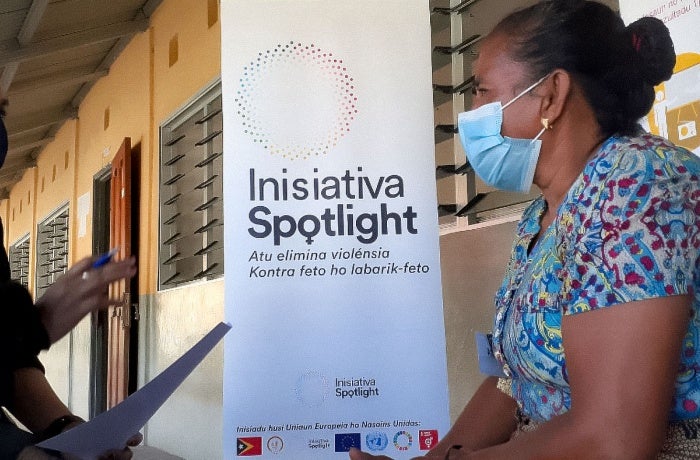 UN Women staff member Gerdrudes Abedita helps a mother complete a form during a Positive Parenting Session in Bobonaro municipality of Timor-Leste on 28 September 2021. Photo: UN Women/Helio Miguel 