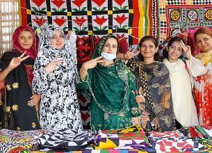 Women sell handicrafts on 13 July 2021 at the Peace Café in Thatta city, Pakistan. The café, a women’s gathering place, was established with the support of UN Women. Photo: UN Women/Anam Abbas
