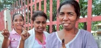 Youth voters dip their fingers into the indigo-blue dye. Photo: UN Women/Betsy Davis Cosme
