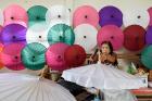A woman works on a parasol in Chiang Mai, northern Thailand.