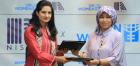 Sharmeela Rassool, Country Representative, UN Women Pakistan and Wajeeha Khalid - Business Head, Nishat Mills Ltd (Apparel Division) exchanging the signed agreements. Photo: UN Women/Anam Abbas