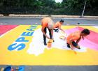 In a road painting message, students taking part in the 17 June event encourage the people of Quezon City to speak out against sexual violence. Photo: UN Women/Dominic Mananghaya