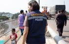 A female immigration officer stands on the Thai-Myanmar Friendship Bridge I. Photo: UN Women/Stephanie Simcox