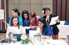 Participants absorbed in group work to build their own training modules. Photo: UN Women/Cecilia Truffer