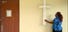The woman touches a cross at the Catholic church in Suva, Fiji, on 15 September, 2021.  She was attending a Sarah Carer meeting there. Photo: UN Women/Miho Watanabe