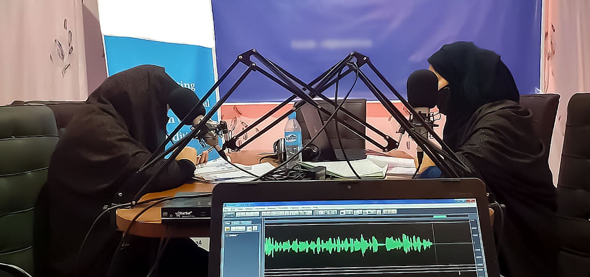 Two female radio presenters record programmes in their studio in western Afghanistan. Photo: Courtesy of Radio Femme
